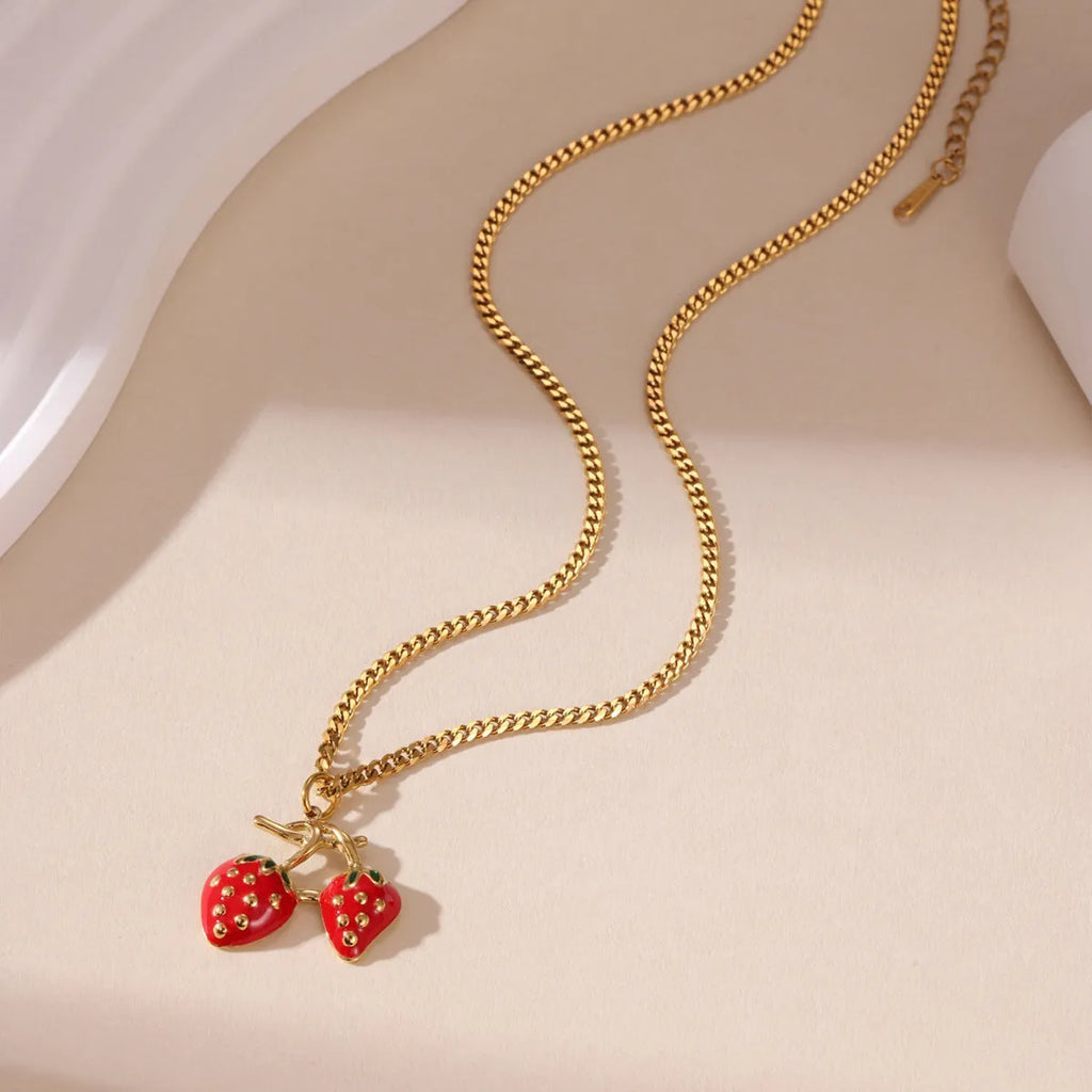 Stainless steel strawberry fruit pendant necklace for women showing red and white gradient colour options