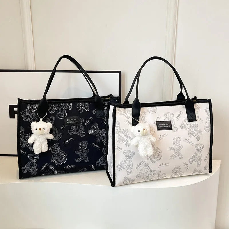 Women's black canvas tote bag with rhombus print pattern and shoulder strap