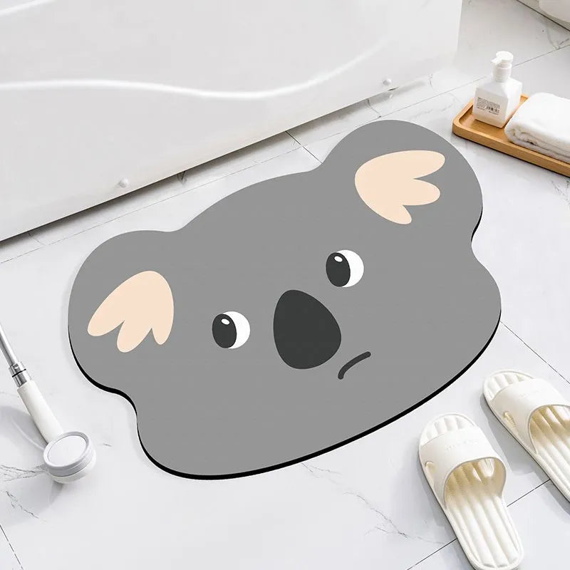 Cartoon animal diatom ooze absorbent bathroom mat in alien shape on bathroom floor.