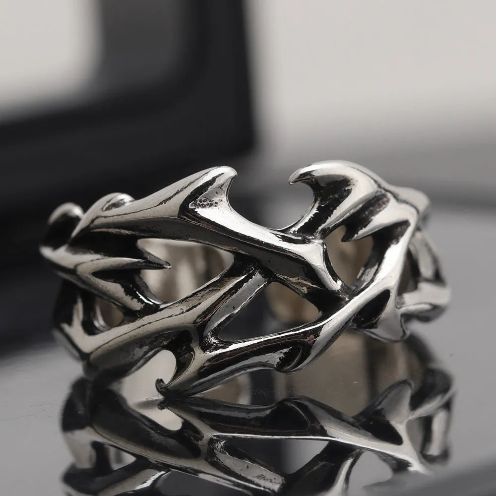 Copper thorn flower geometric ring with adjustable opening on a flat surface.