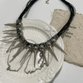 Women's leather winding tassel necklace with round beads and silver rivet details