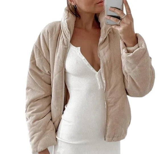 Apricot coloured women's corduroy zip jacket with stand collar and long sleeves on a hanger.