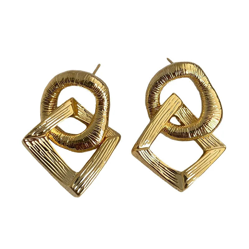Gold and silver geometric circle pendant earrings with a 3.4cm drop length on a white background.