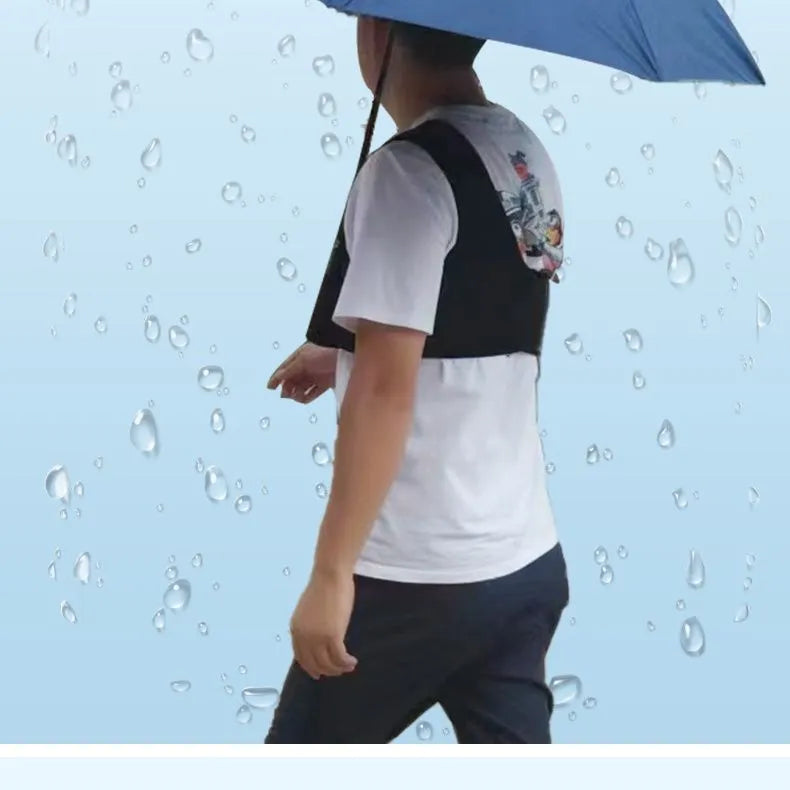 Black portable umbrella holder with a fixed shoulder strap, shown holding a manual folding umbrella.