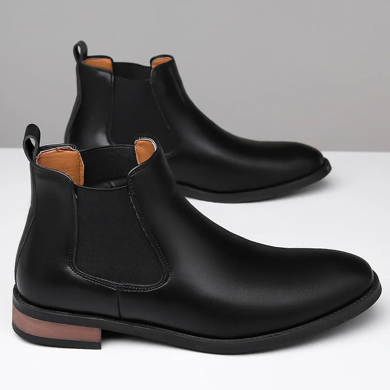 Men's black pointed-toe Chelsea boots with a high-top, mid-calf design and a low rubber sole.