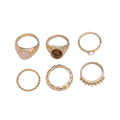 Six light gold geometric alloy rings arranged as a set showing geometric shapes and round elements
