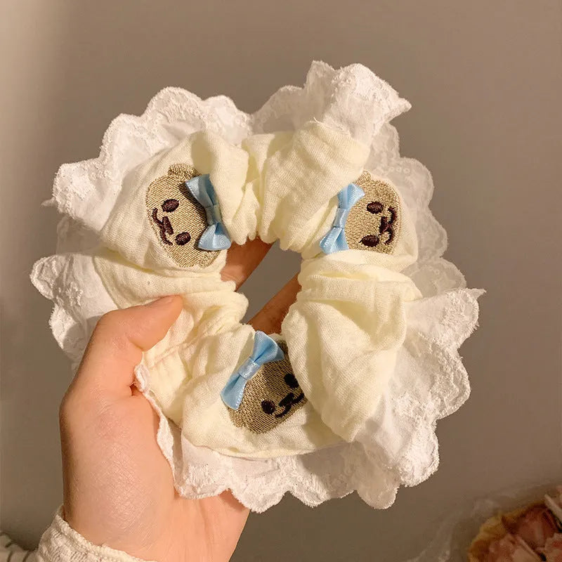 Blue cloth hair ring with cute bear and bow design in a large intestine loop style.