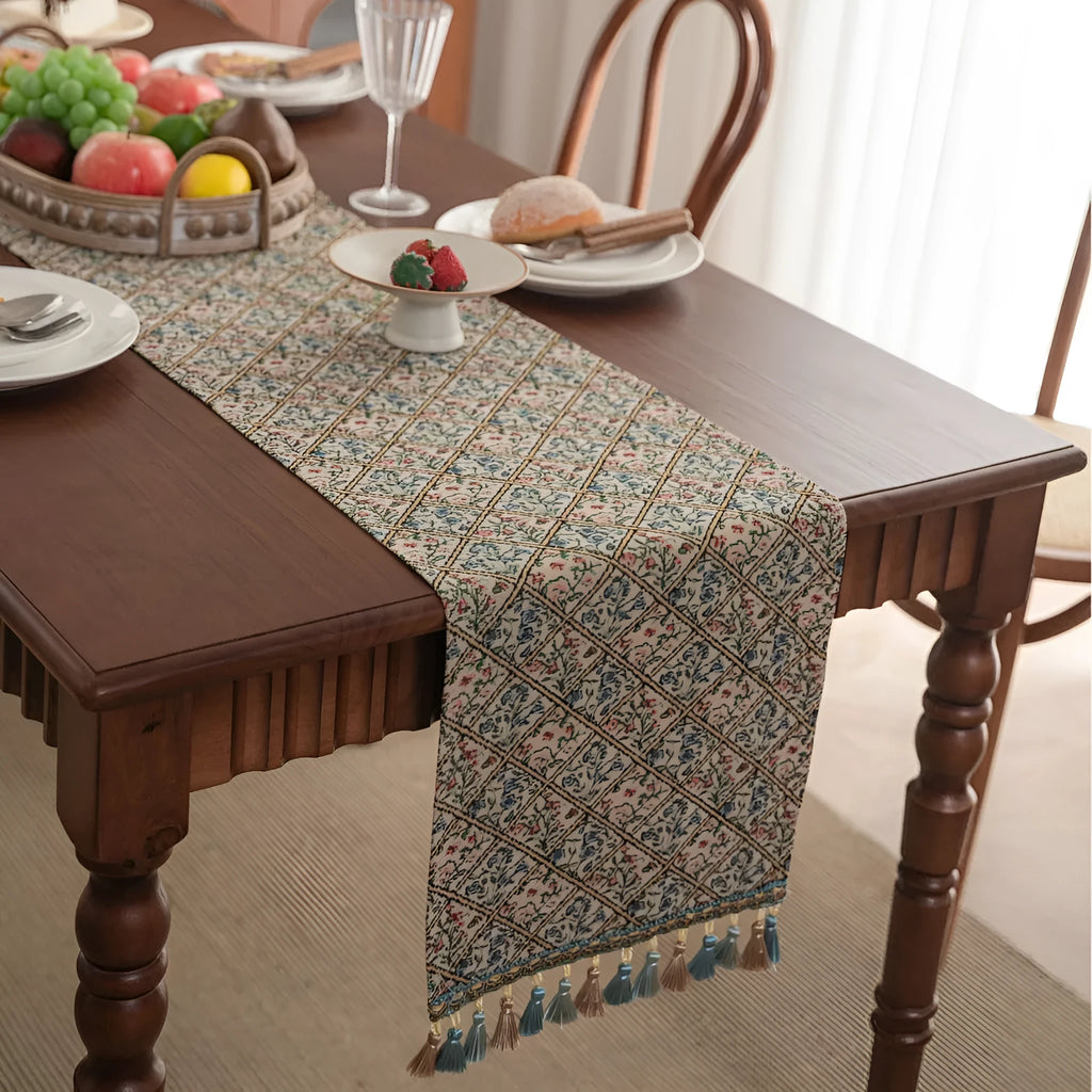 Rhyme Nordic jacquard table runner with tassel trim in a striped pattern, laid flat on a wooden table.