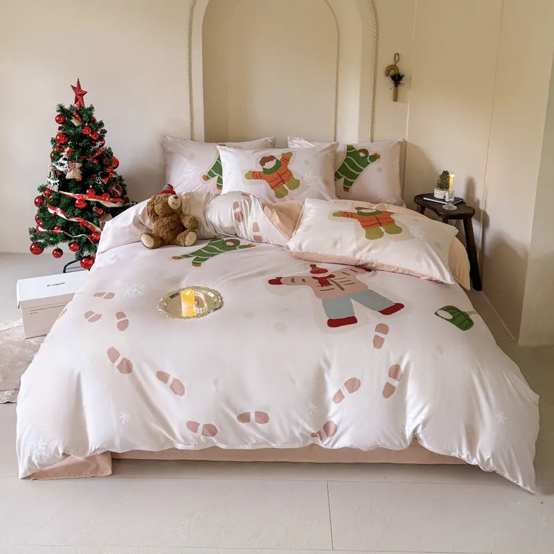 Christmas cartoon themed four-piece bedding set with duvet cover, fitted sheet and pillowcases on a bed.