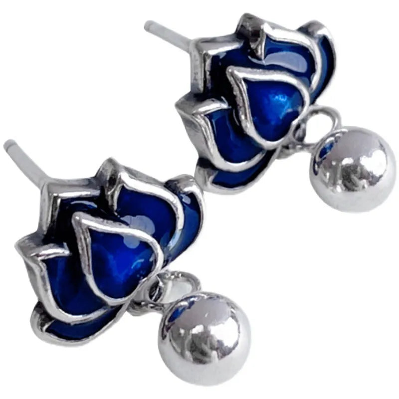 Blue lotus flower alloy ear studs with a retro seedpod tassel, shown from the front.