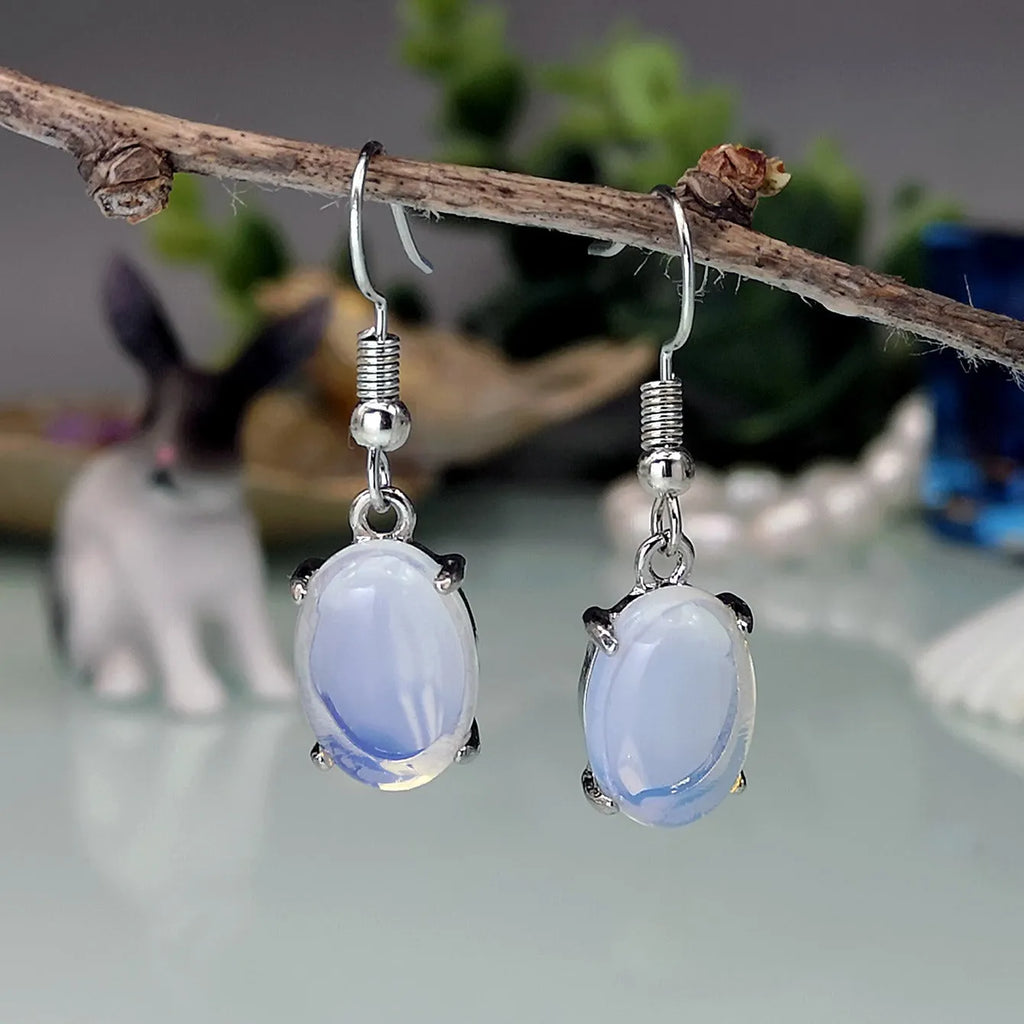 Opal earrings with retro moonstone aesthetic, cross design and ellipse pendant in drop shape