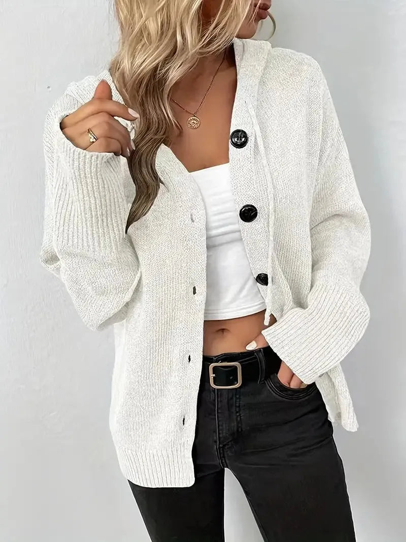 A solid colour hooded cardigan sweater with a textured 3D pattern, shown in a loose fit.