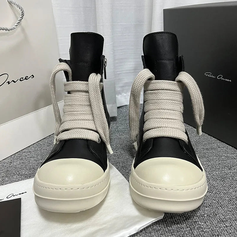 Black high-top leather sneakers with a side zipper and round toe on a rubber sole.