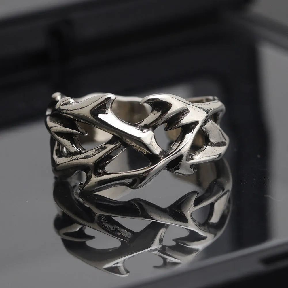 Copper thorn flower geometric ring with adjustable opening on a flat surface.