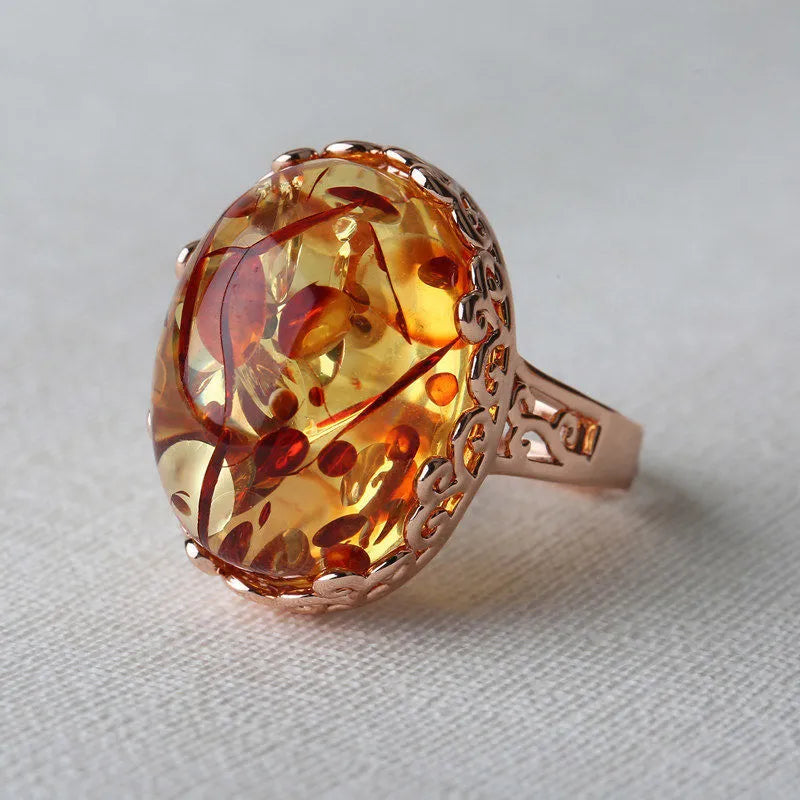 Amber beeswax ring with natural stone in ethnic style on alloy band