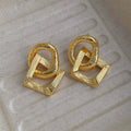 Gold and silver geometric circle pendant earrings with a 3.4cm drop length on a white background.