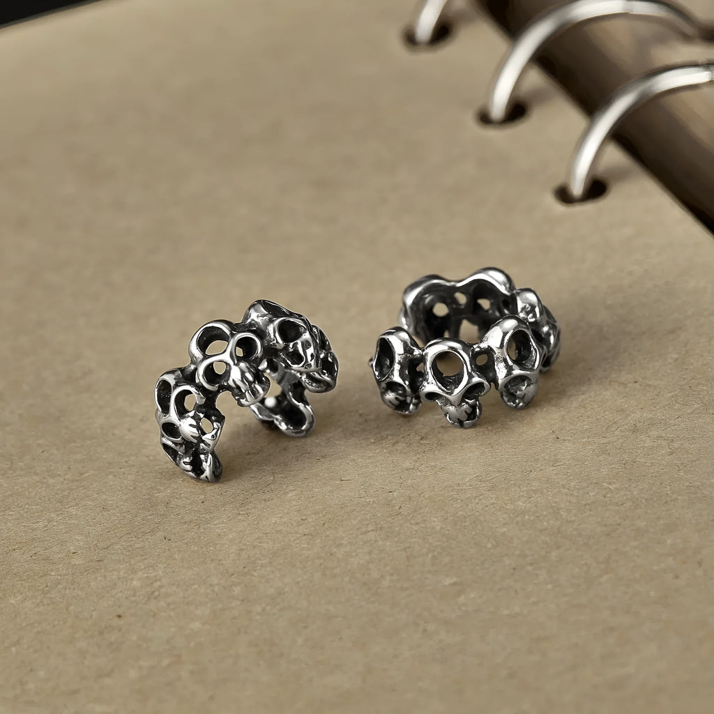 Stainless steel hollow skull ear clips with geometric design and steel colour finish