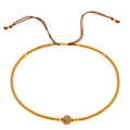 Handmade bohemian bracelet with colourful semi-precious stones and glass beads in geometric patterns.