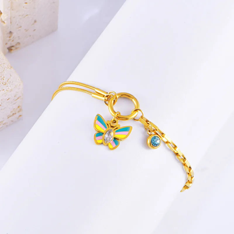 Gold titanium steel necklace and bracelet set with colourful epoxy butterfly pendant on snake bone chain.