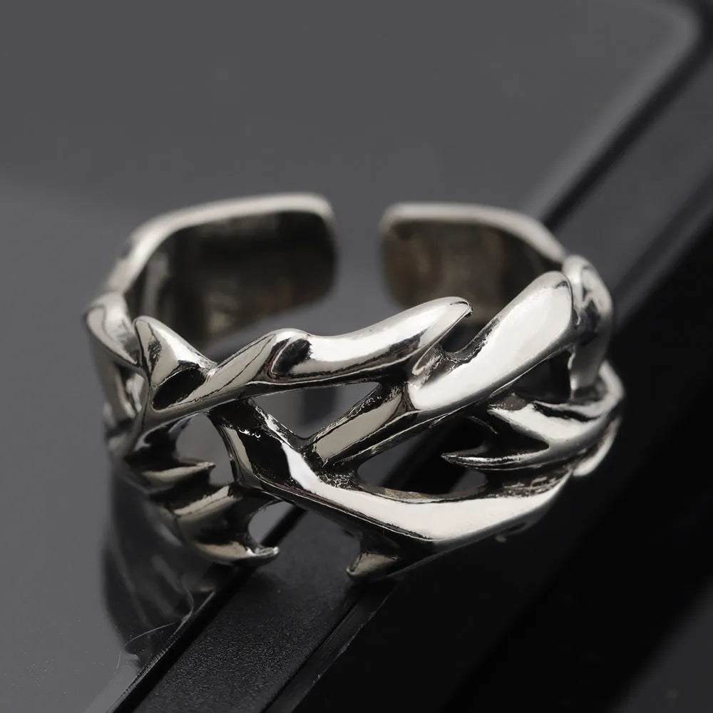 Copper thorn flower geometric ring with adjustable opening on a flat surface.
