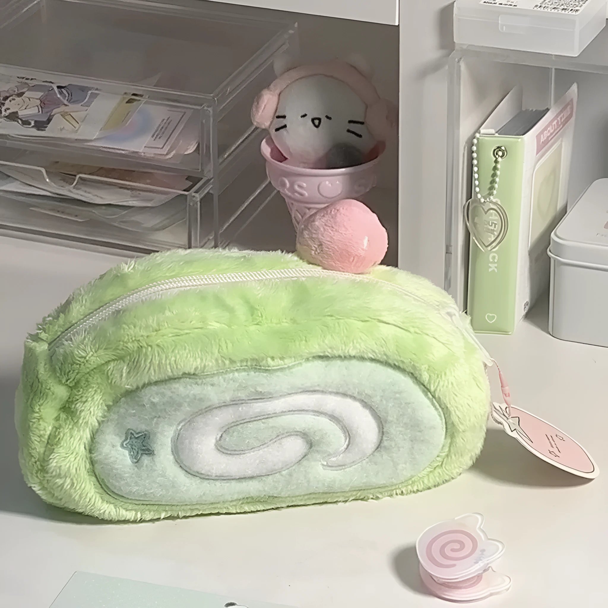 Soft velvet pencil case with Swiss roll cake design, rolled up.