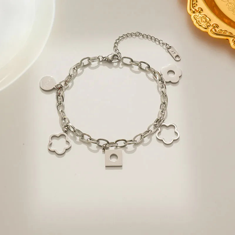 Titanium steel flower small pendant bracelet for women in gold electroplated finish