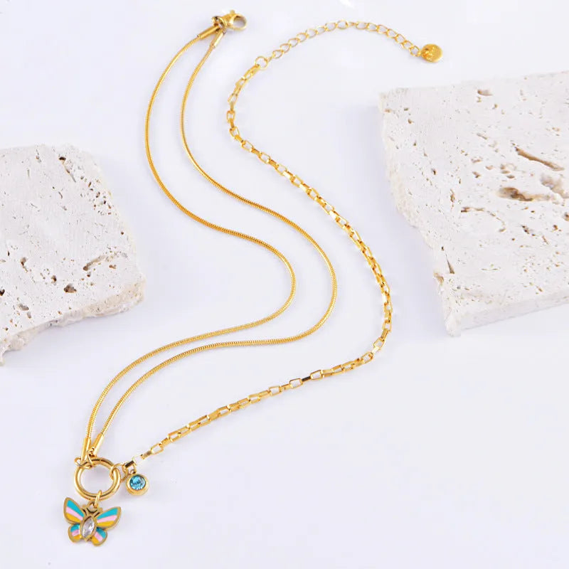 Gold titanium steel necklace and bracelet set with colourful epoxy butterfly pendant on snake bone chain.