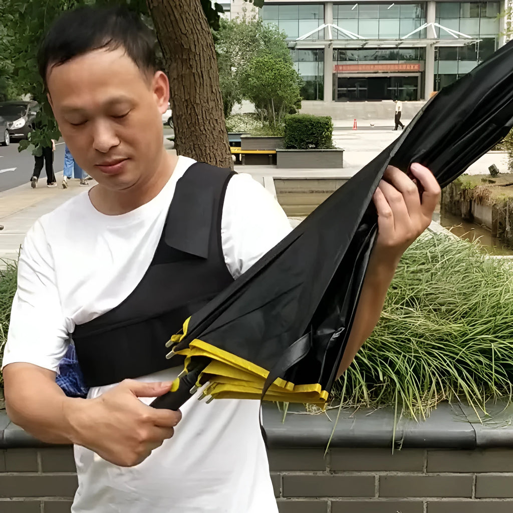 Black portable umbrella holder with a fixed shoulder strap, shown holding a manual folding umbrella.