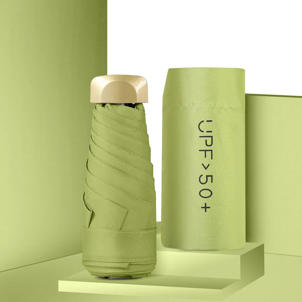 Closed five-fold compact sun umbrella with a rubber handle, shown in a selection of colours including black, yellow, green, and pink.