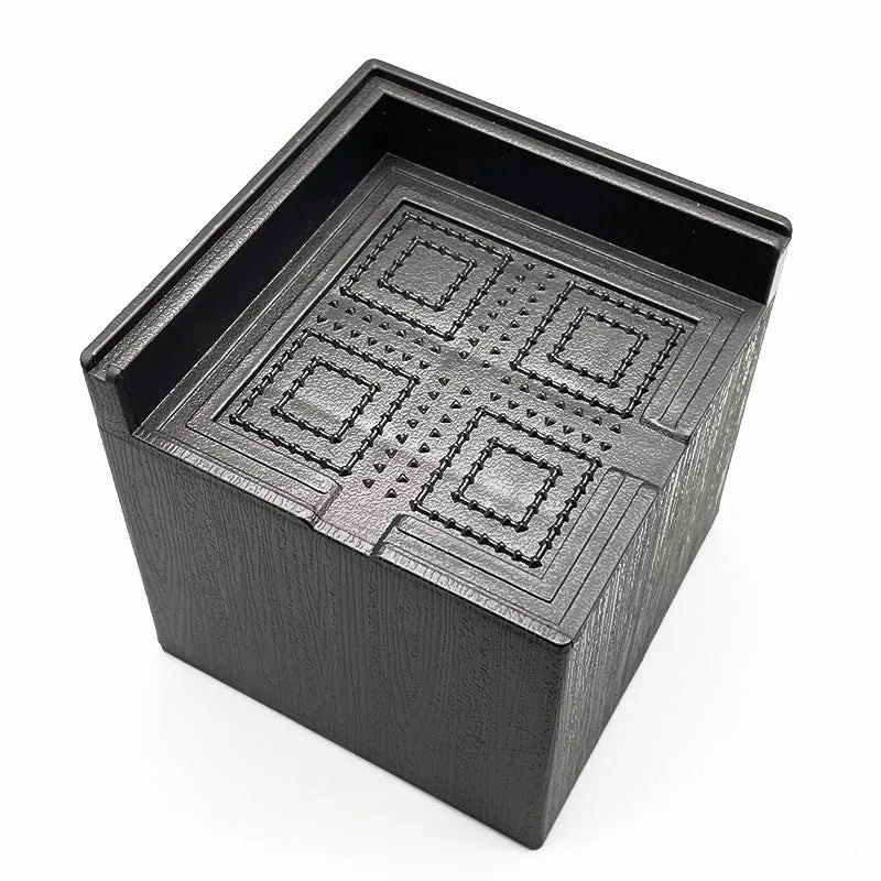 Four black plastic bed foot mats for sofa height increase on hard flooring
