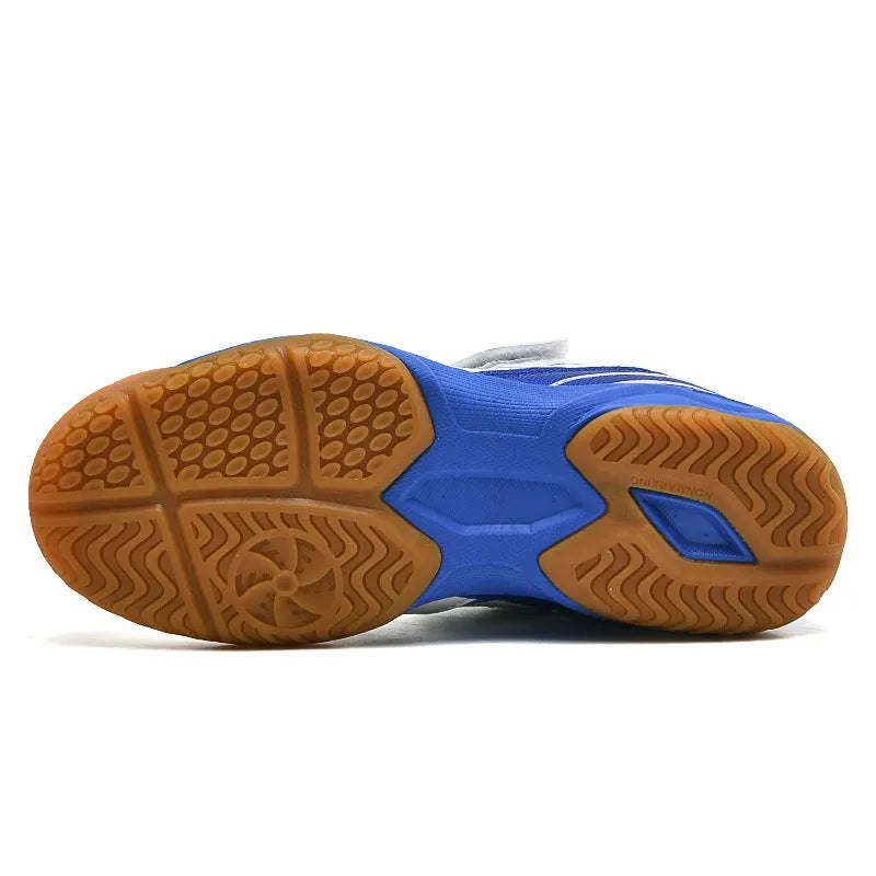 White and blue low-top badminton shoes with a ribbed sole and casual round-toe design on a court surface.