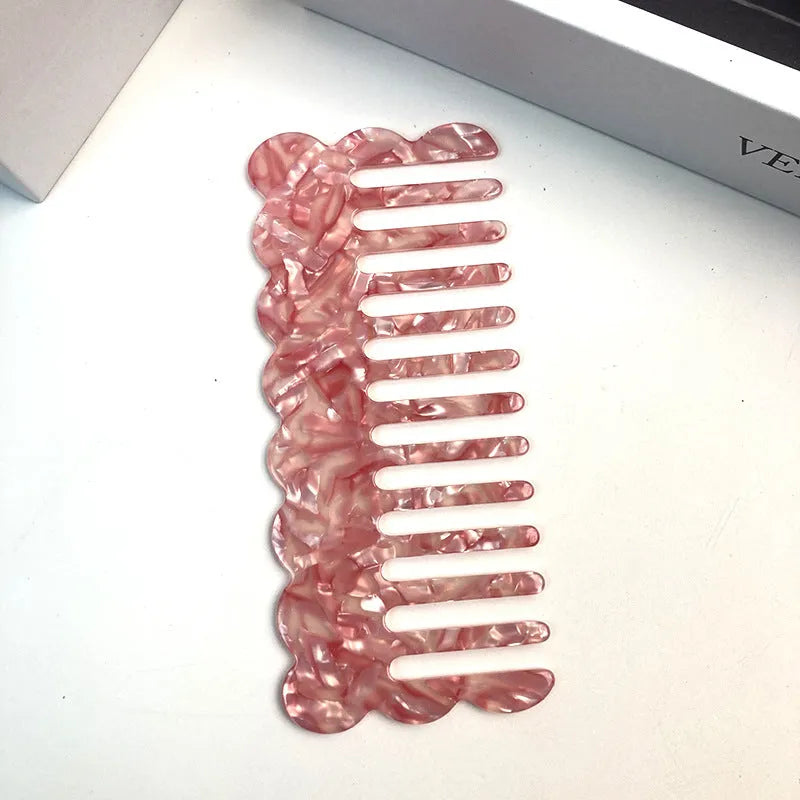 Acetate hair comb with geometric retro wave design in various colours.