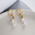 Gold copper irregular French pearl pendant earrings with geometric-shaped drop, 5 cm length, on white background