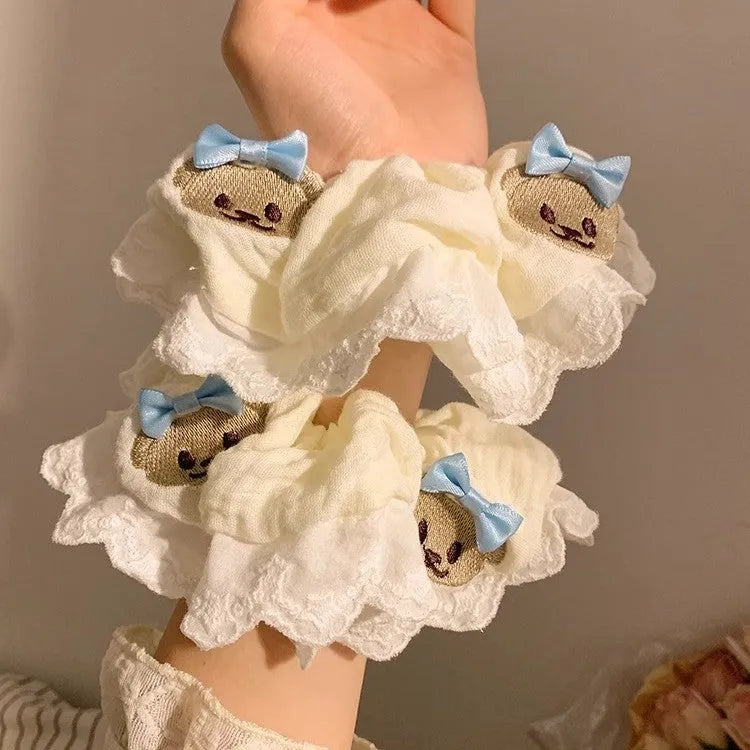 Blue cloth hair ring with cute bear and bow design in a large intestine loop style.