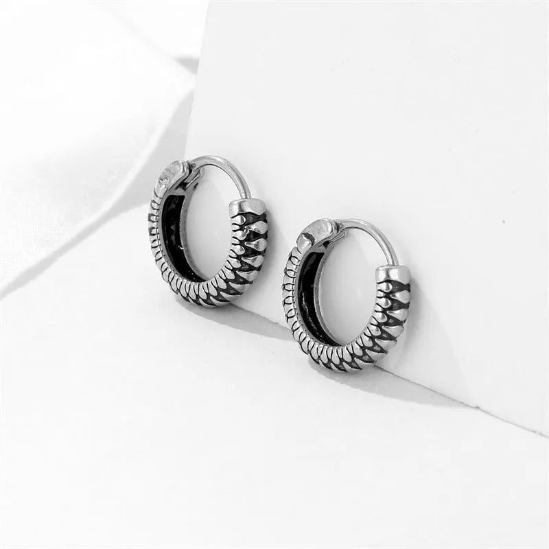 Silver geometric retro twist earrings made from titanium steel alloy with stripe detailing.
