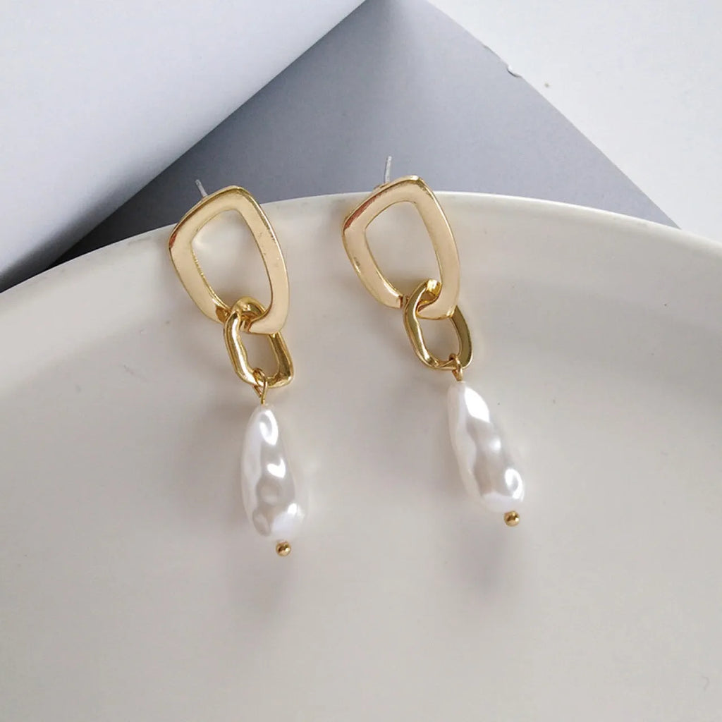 Gold copper irregular French pearl pendant earrings with geometric-shaped drop, 5 cm length, on white background