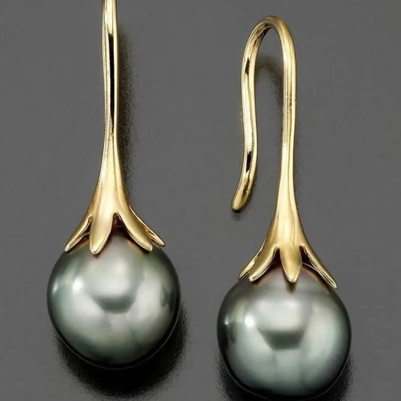 Pair of retro-style gold-coloured fashion earrings for women with creative design.
