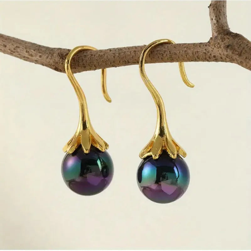 Pair of retro-style gold-coloured fashion earrings for women with creative design.