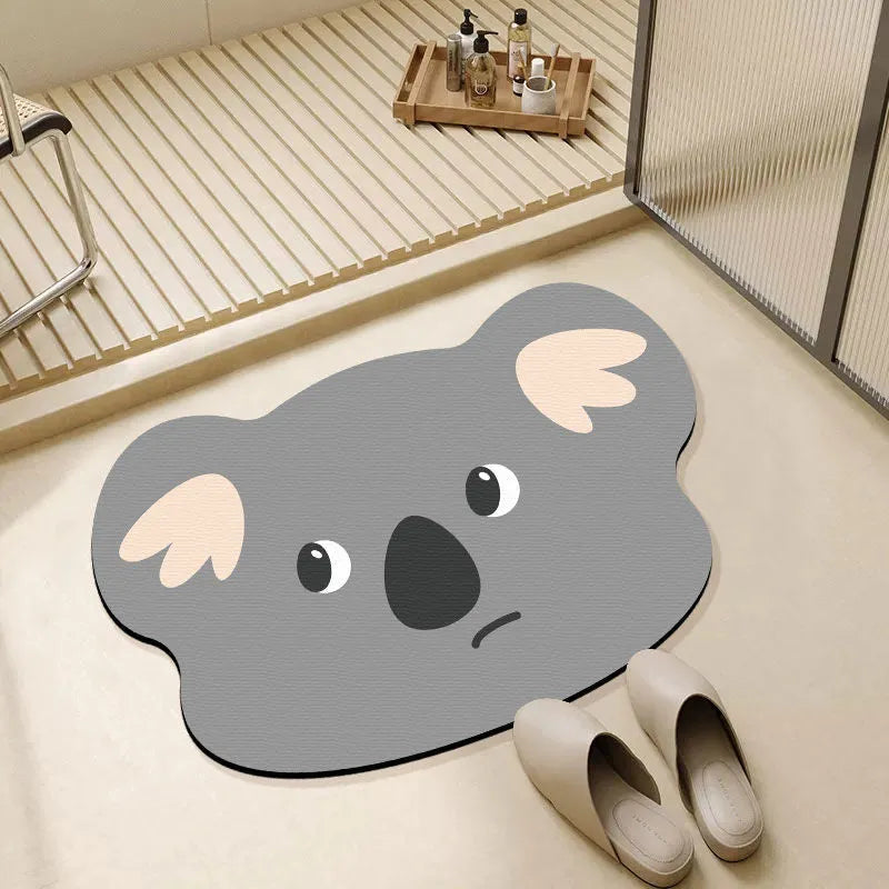 Cartoon animal diatom ooze absorbent bathroom mat in alien shape on bathroom floor.