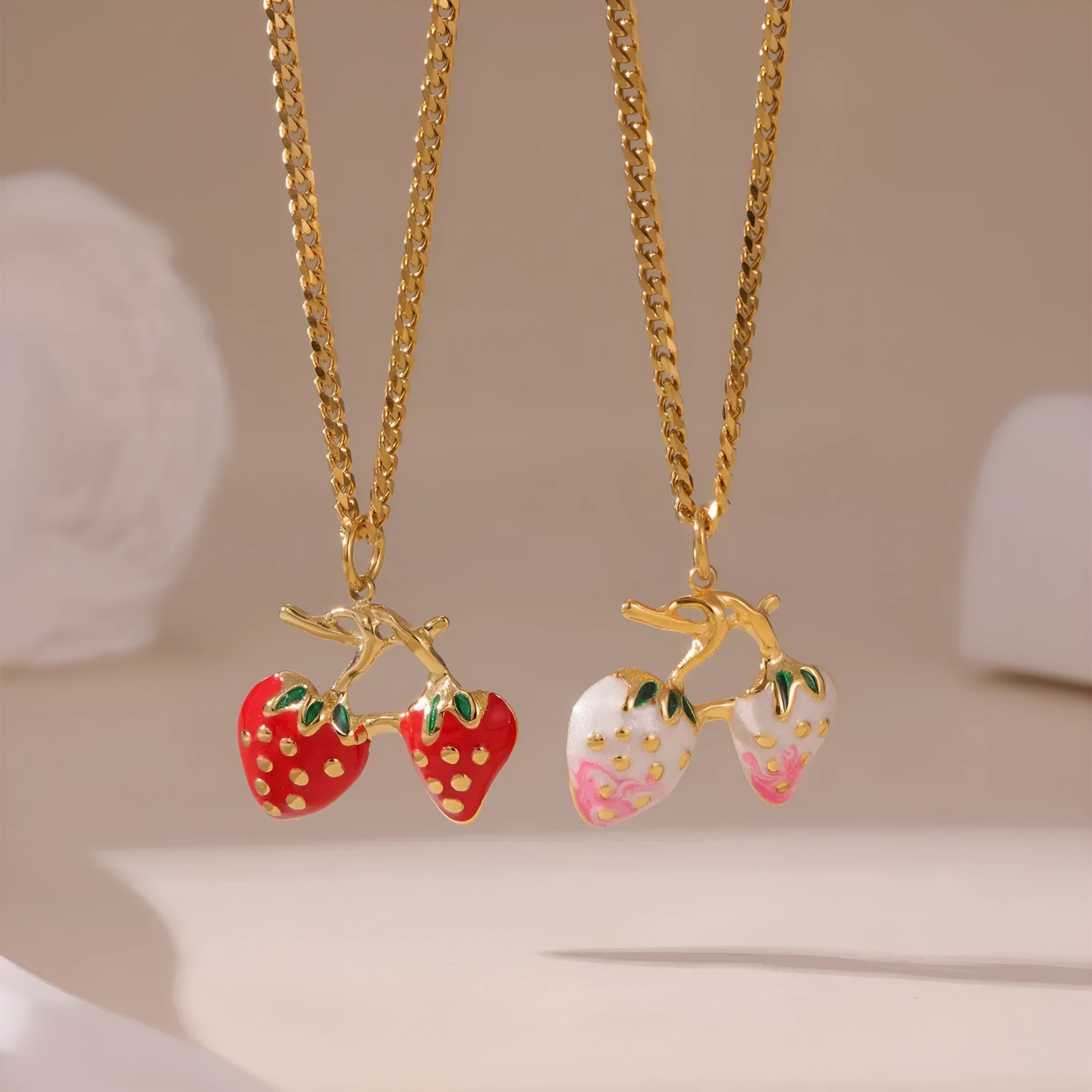 Stainless steel strawberry fruit pendant necklace for women showing red and white gradient colour options