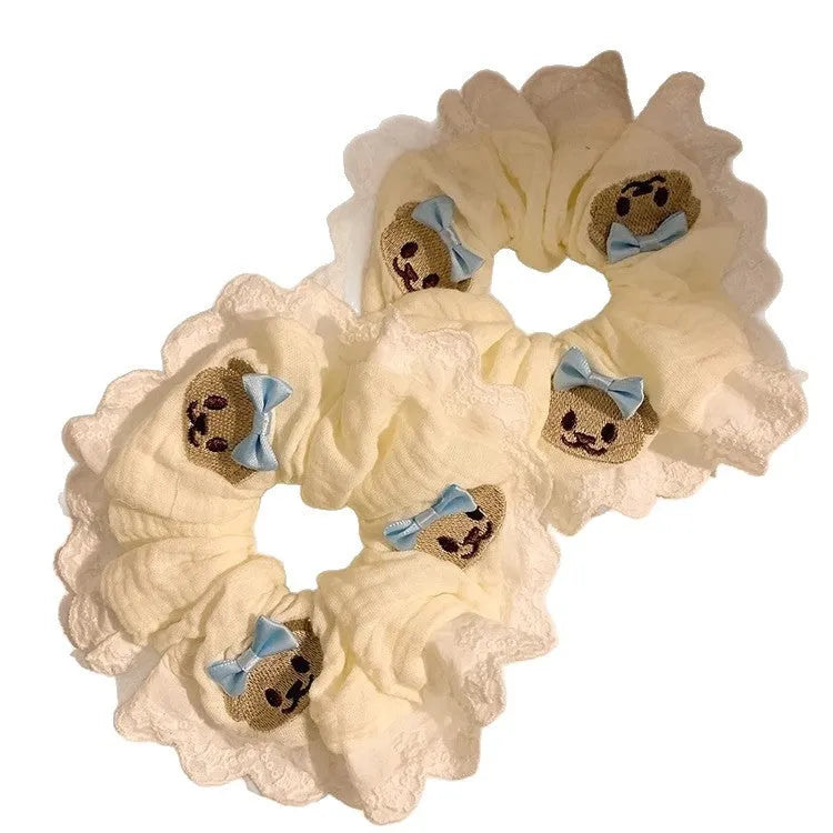 Blue cloth hair ring with cute bear and bow design in a large intestine loop style.