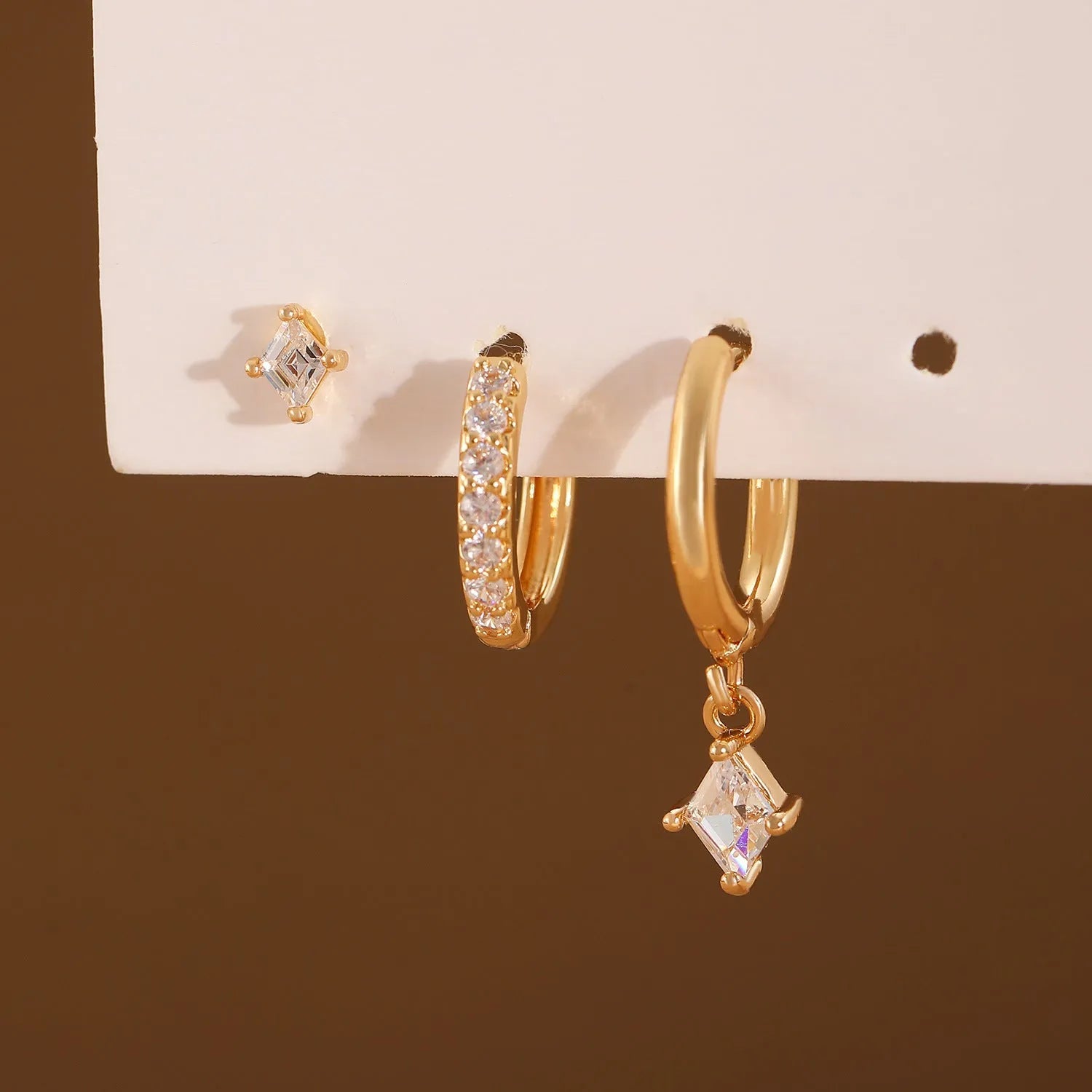 Ladies three-piece earring set with geometric design and zircon inlaid accents in gold colour