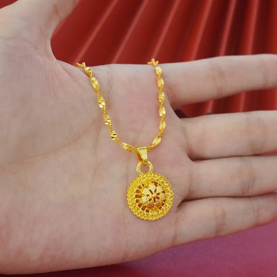 Gold-plated three-piece jewellery set with floral design pendant, matching earrings and ring on water wave chain