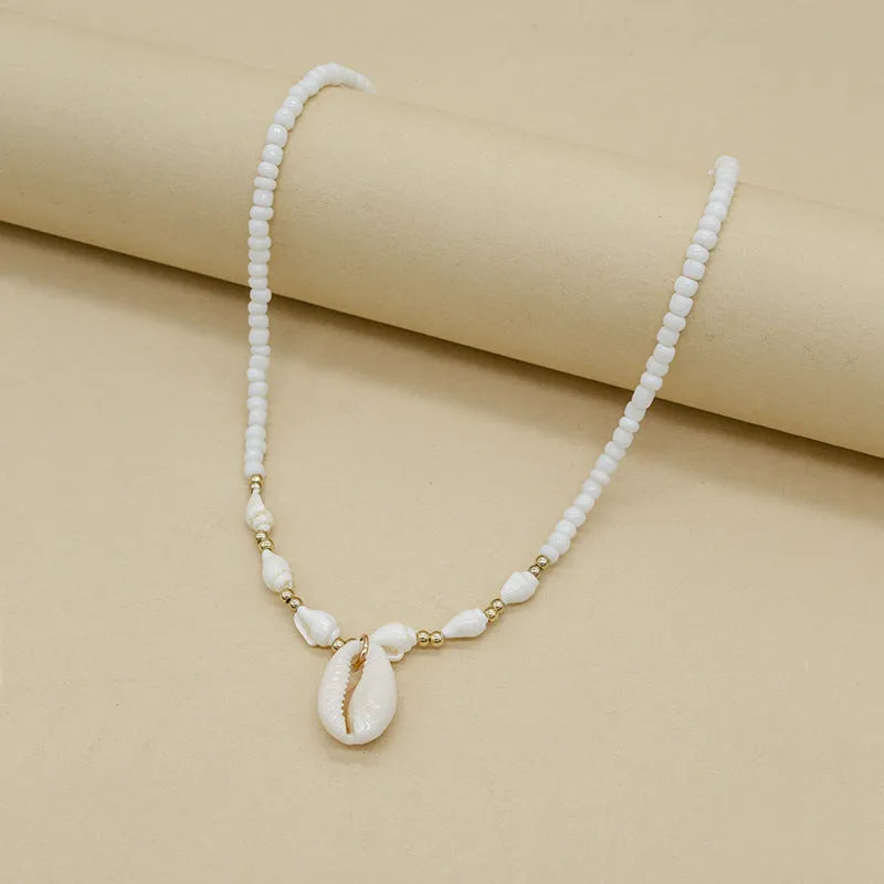 White conch shell bead necklace with mother pearl pendant on regular chain, electroplated finish