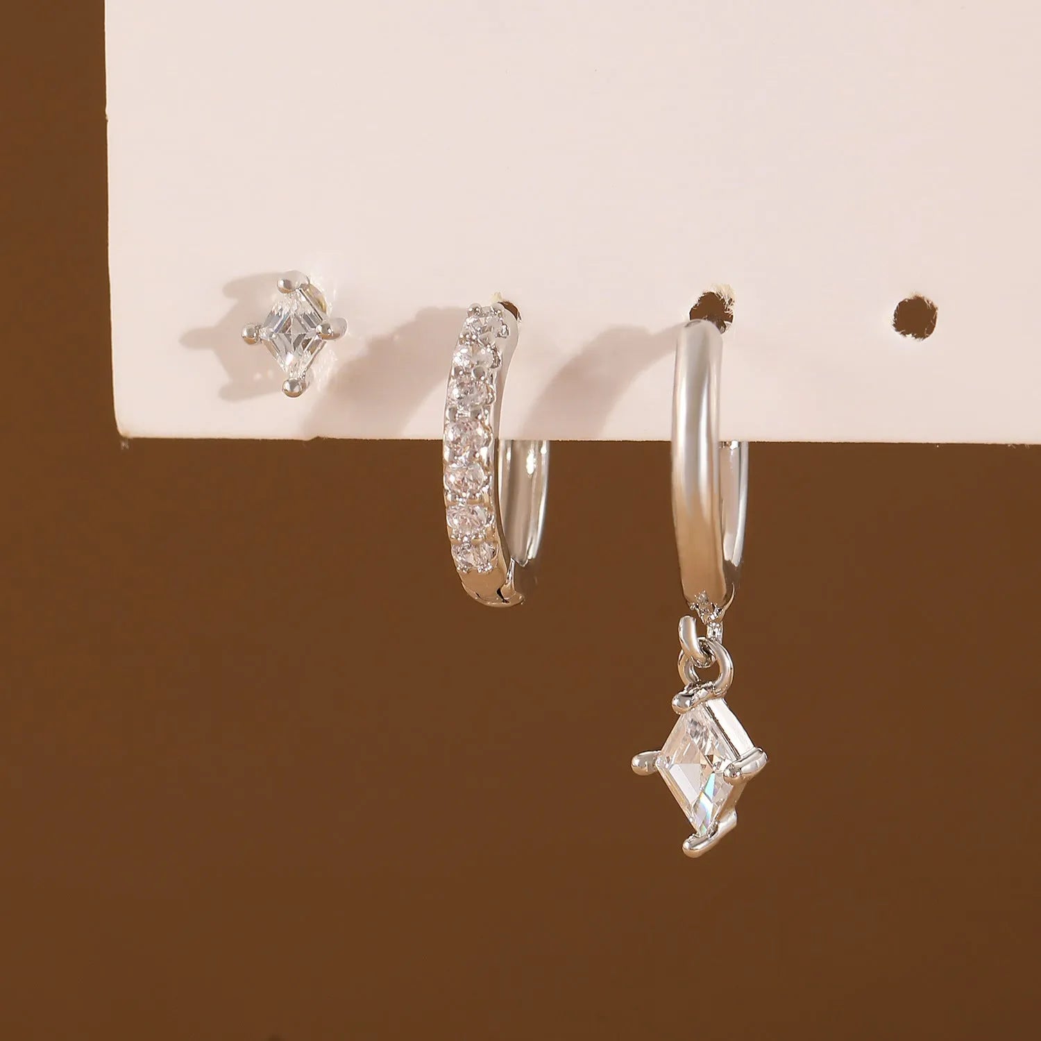 Ladies three-piece earring set with geometric design and zircon inlaid accents in gold colour