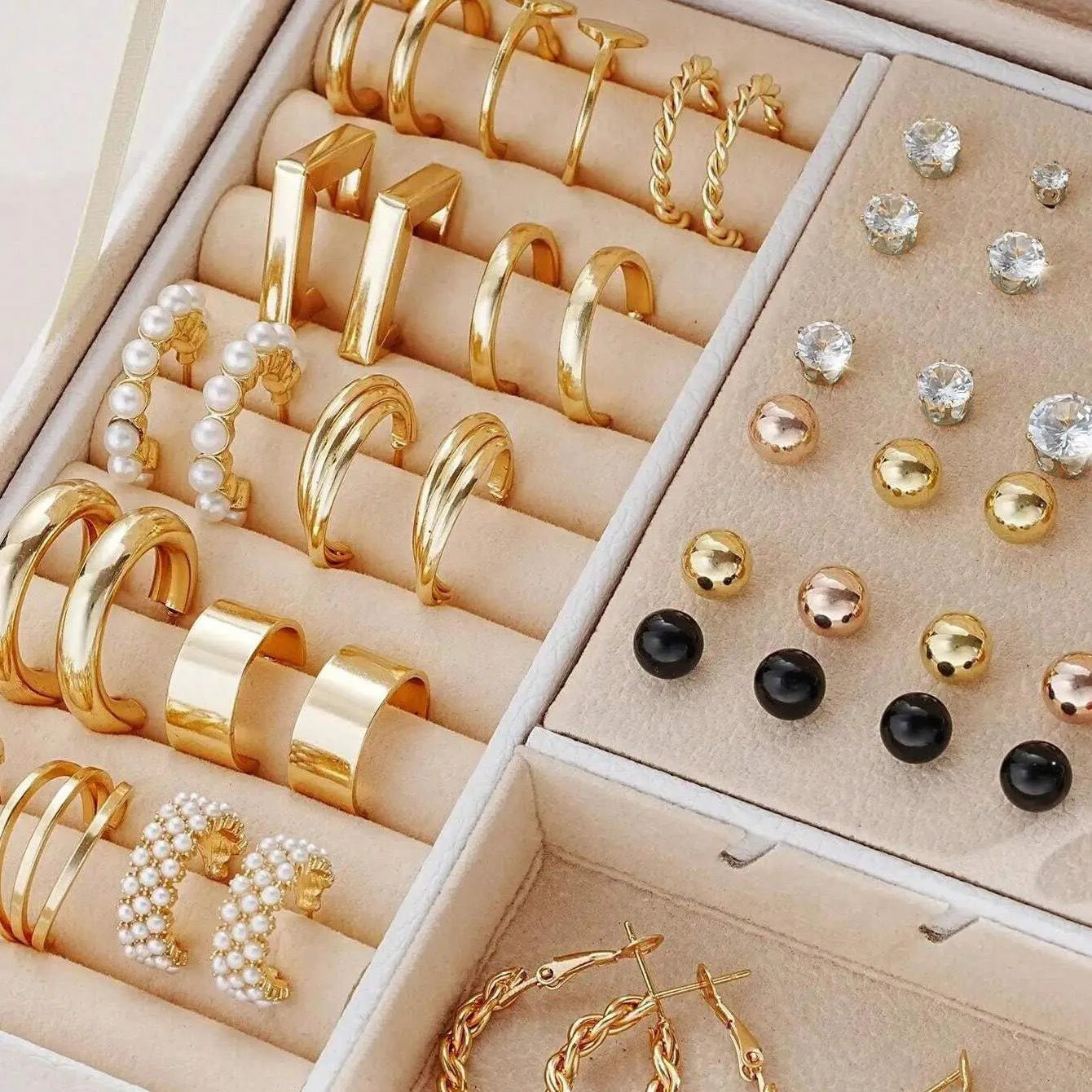 108 gold and yellow geometric alloy earrings with round bead details laid out flat.