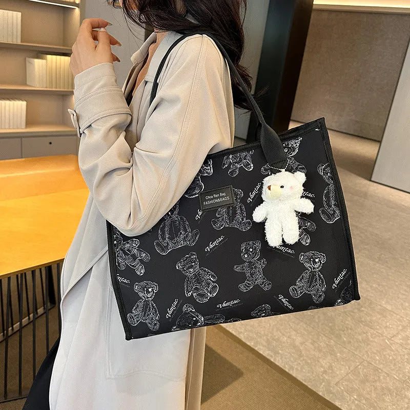 Women's black canvas tote bag with rhombus print pattern and shoulder strap