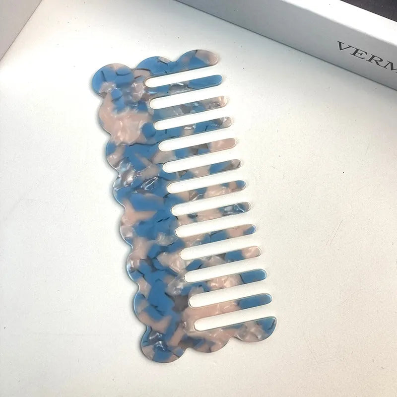 Acetate hair comb with geometric retro wave design in various colours.