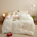 Milk fibre bedding four-piece set with green Christmas tree pattern showing quilt cover, sheet, and pillowcase