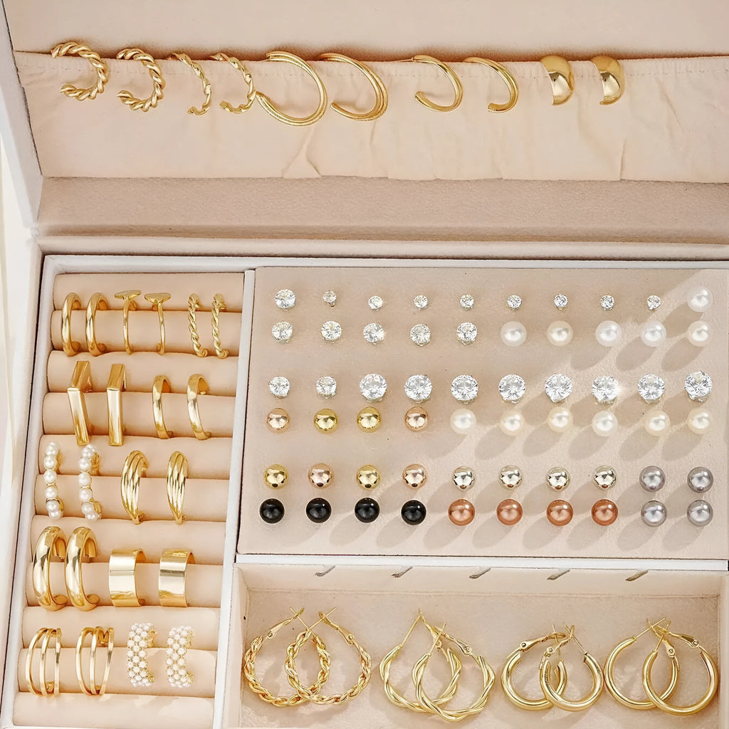 108 gold and yellow geometric alloy earrings with round bead details laid out flat.
